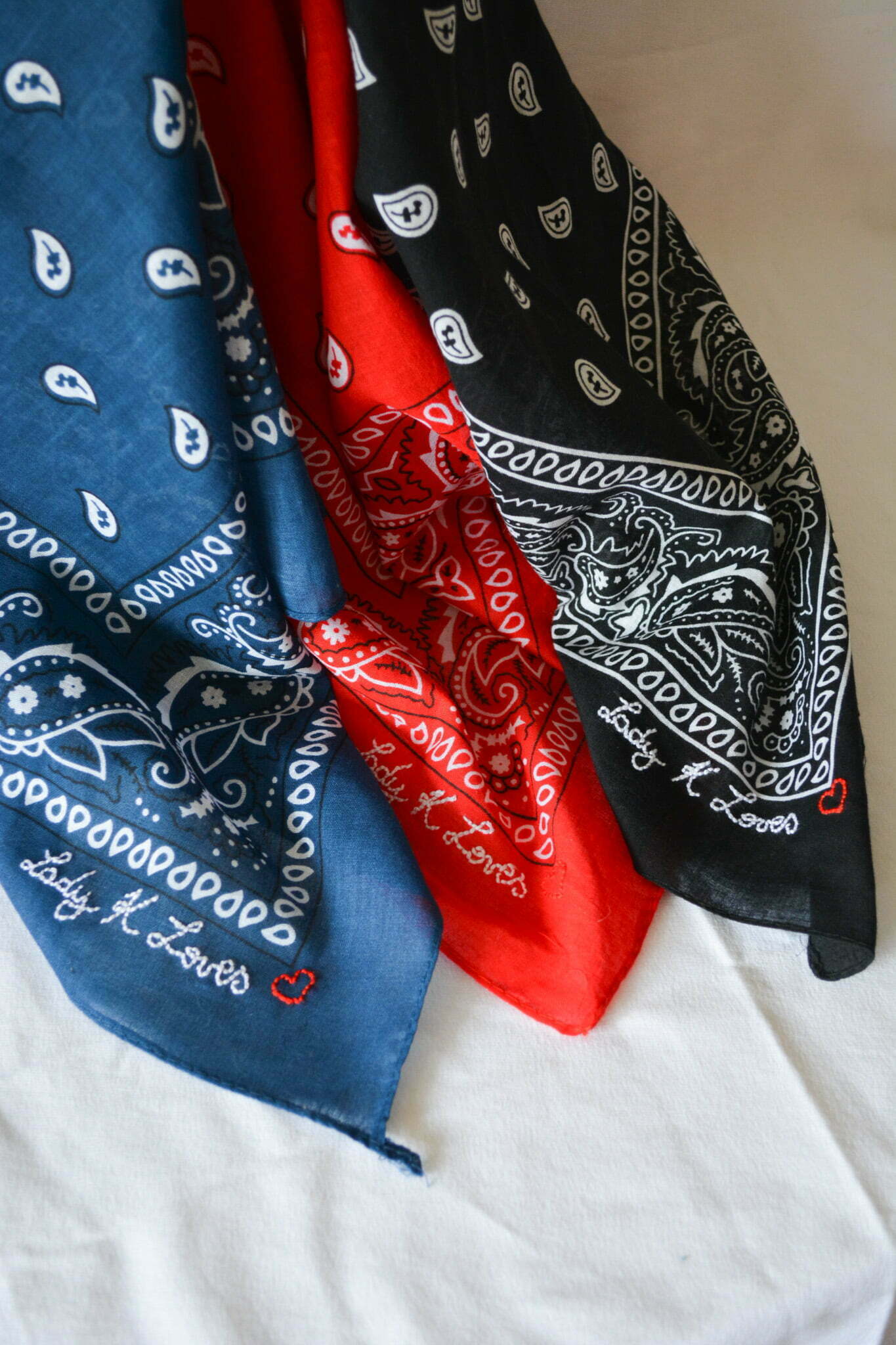 three paisley bandanas draped together red nevy blue black
